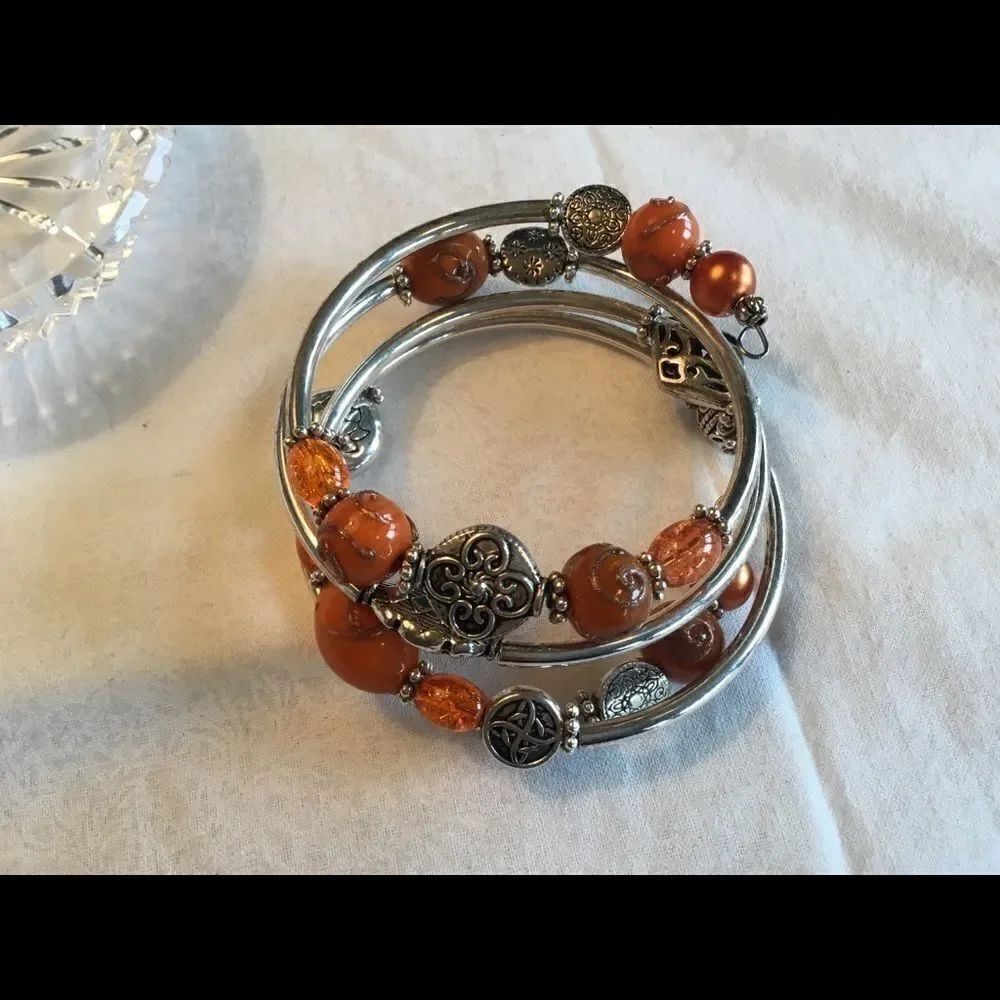 $10 ea or 3/$20. Silvertone Orange Beads Coil Brac